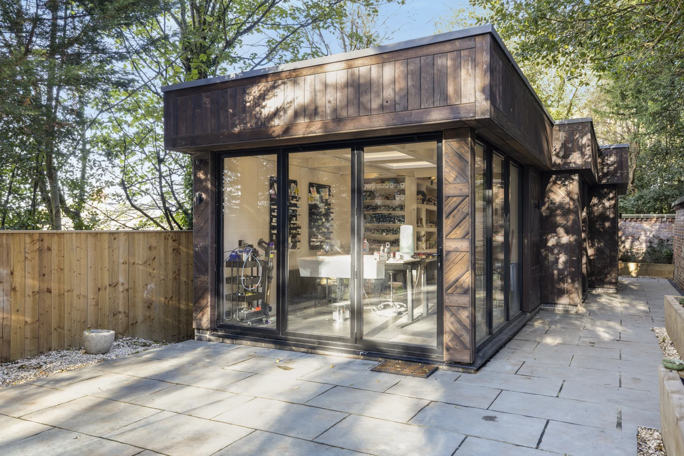 Timber-clad art studio opening onto a secluded garden